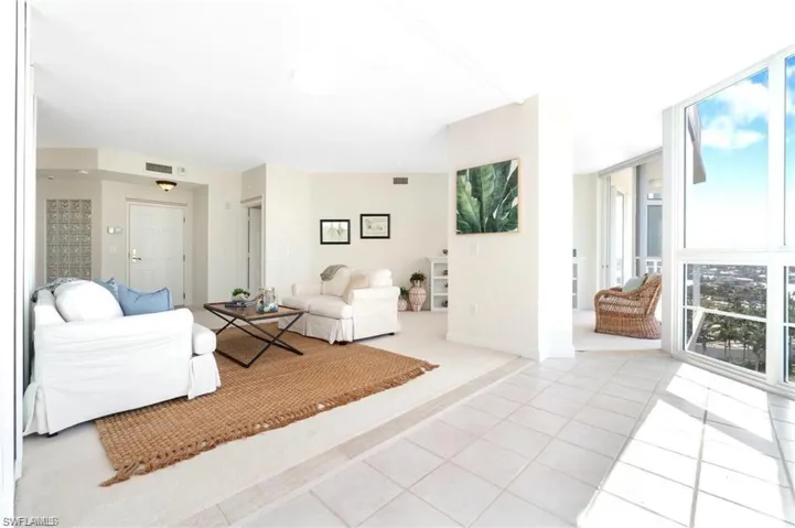 Tiled living room featuring a wealth of natural light