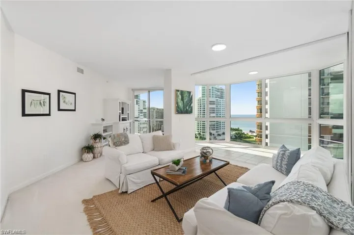 Living room featuring a water view and carpet flooring
