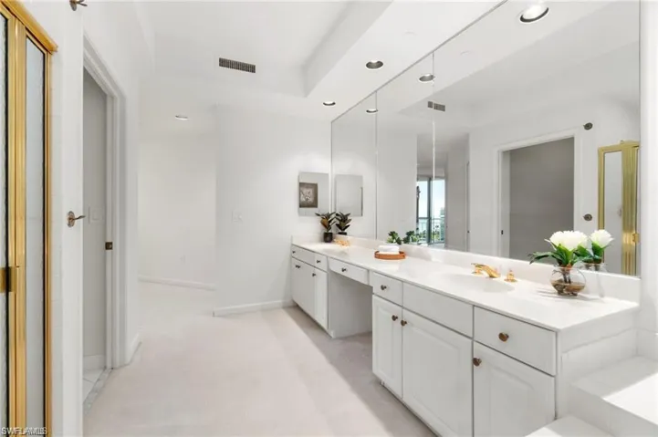 Bathroom with vanity and a bath