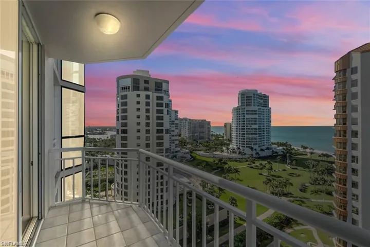 Balcony at dusk featuring a water view