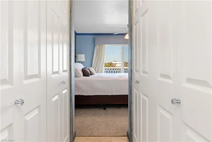 Bedroom featuring a closet, a textured ceiling, and light carpet