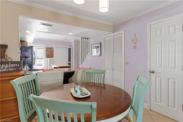 Dining room featuring ornamental molding and light tile patterned floors