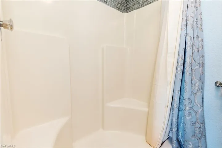 Full bathroom featuring a shower with curtain