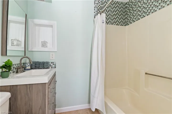 Full bath with vanity and shower / bath combo with shower curtain