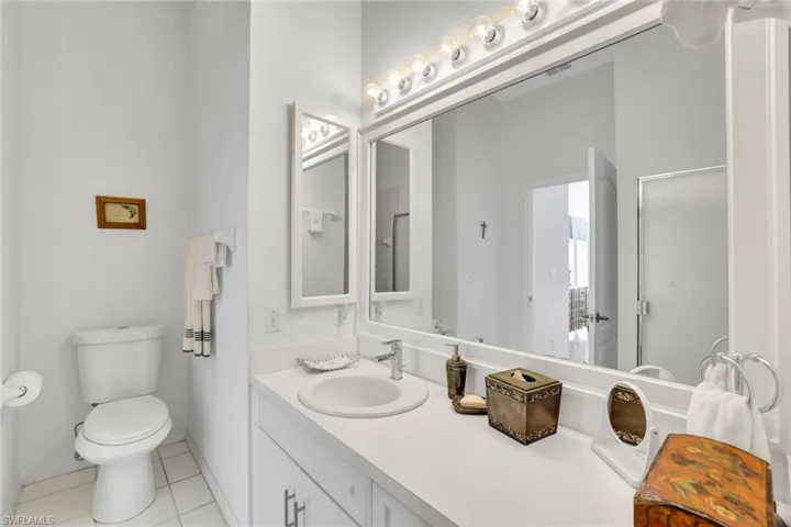Bathroom featuring tile patterned flooring, vanity, and toilet