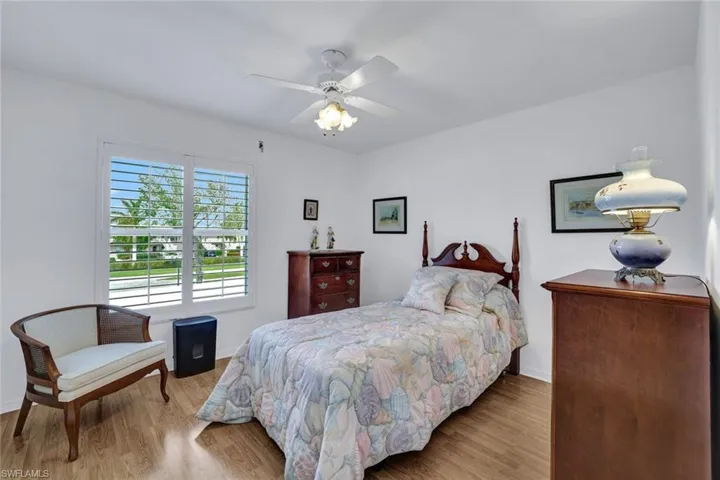 Bedroom with light hardwood / wood-style flooring and ceiling fan