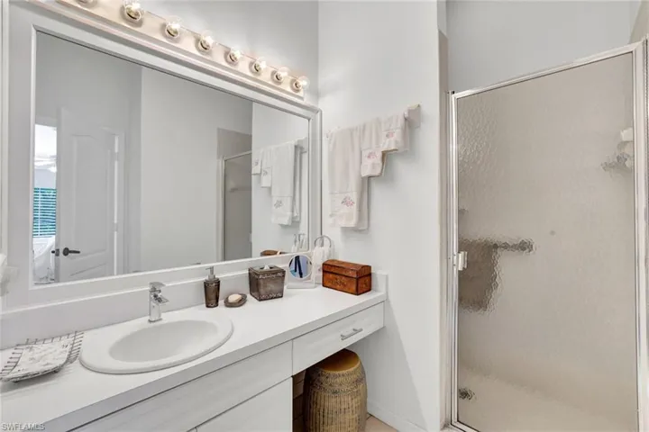 Bathroom featuring vanity and an enclosed shower