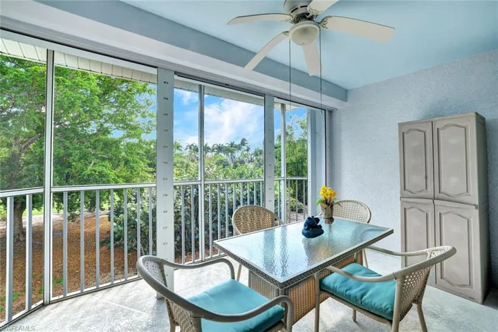Sunroom featuring ceiling fan