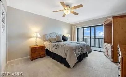 Bedroom featuring access to outside, light colored carpet, and a ceiling fan
