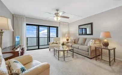 Living area featuring carpet and a ceiling fan