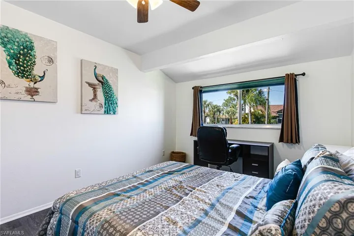 Bedroom featuring a ceiling fan and baseboards