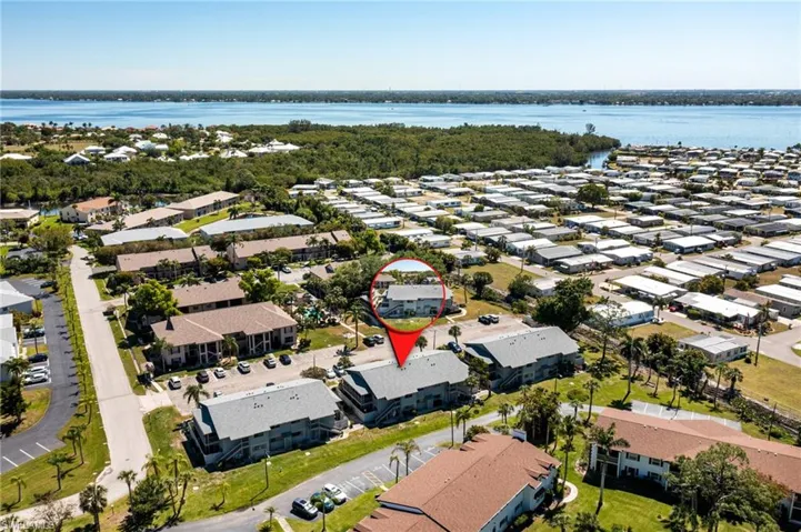Aerial perspective of suburban area featuring a nearby body of water