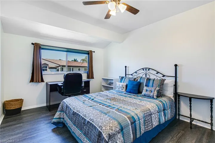 Bedroom with dark wood-type flooring and ceiling fan