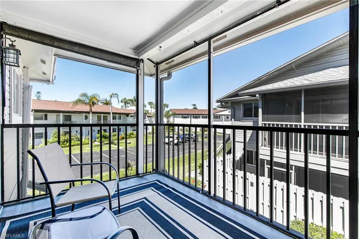 Balcony featuring a sunroom