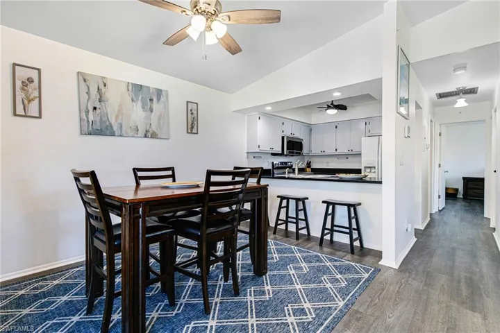 Dining area with ceiling fan, lofted ceiling, and recessed lighting