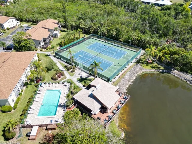 Aerial view of a pool area and a nearby body of water