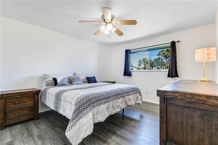 Bedroom with dark wood-style flooring and ceiling fan