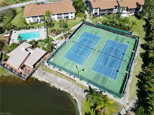 Aerial view of a pool and a nearby body of water