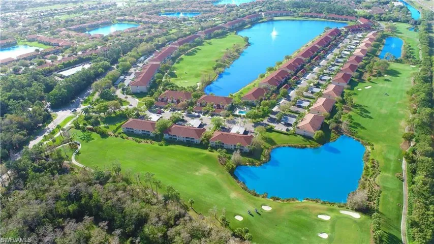 Birds eye view of property with a water view