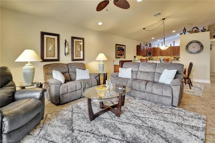 Tiled living room featuring ceiling fan