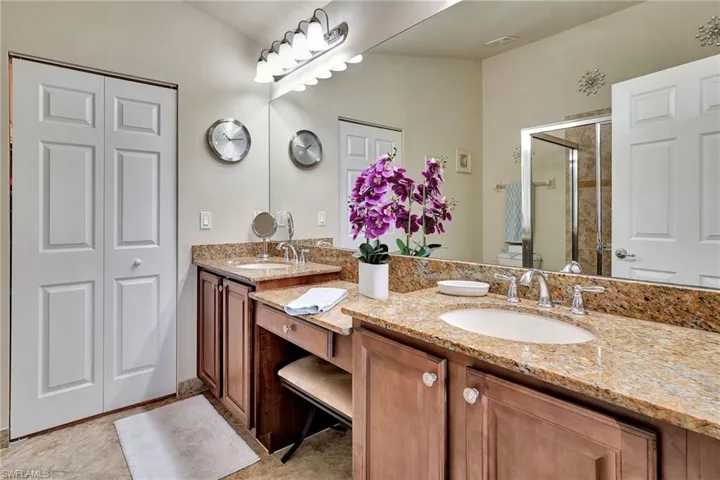 Bathroom with tile patterned floors and double sink vanity