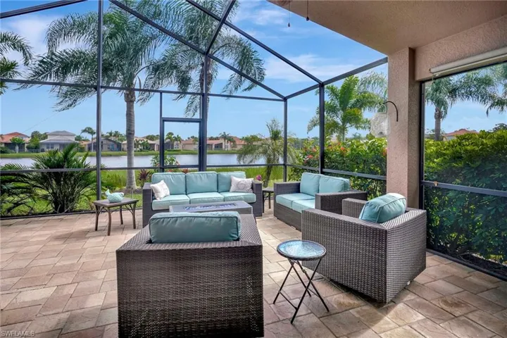 Sunroom / solarium featuring a water view