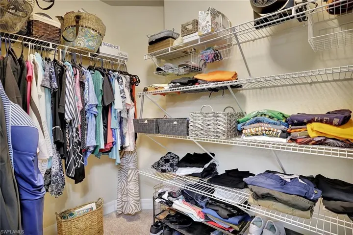 Walk in closet featuring carpet flooring