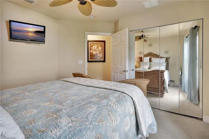 Bedroom featuring carpet, a closet, and ceiling fan