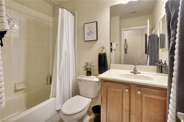 Full bathroom featuring shower / tub combo, toilet, and vanity