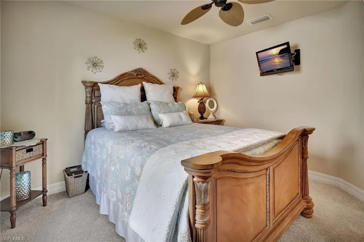 Bedroom with light carpet and ceiling fan