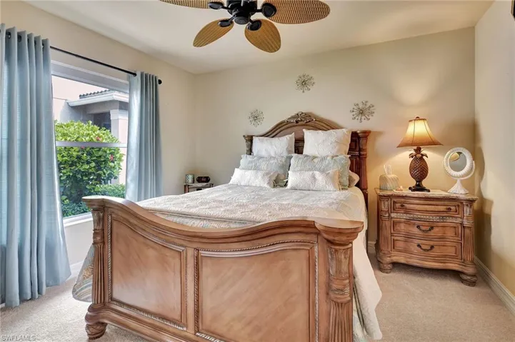 Bedroom featuring light carpet and ceiling fan