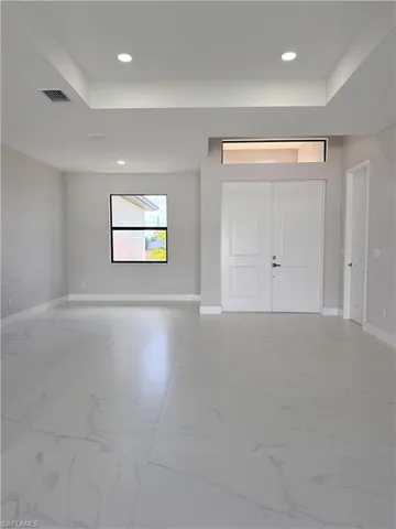 Entrance foyer featuring light marble finish floors