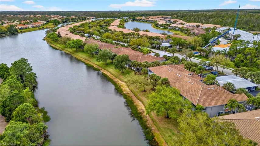 Aerial perspective of suburban area featuring a nearby body of water