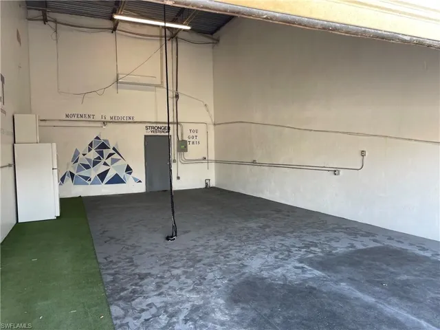 Garage featuring white refrigerator