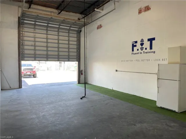 Garage featuring white refrigerator