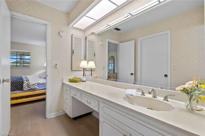 Bathroom with hardwood / wood-style flooring and vanity