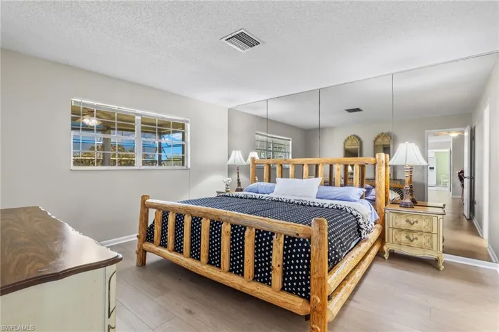 Bedroom featuring a textured ceiling and hardwood / wood-style floors