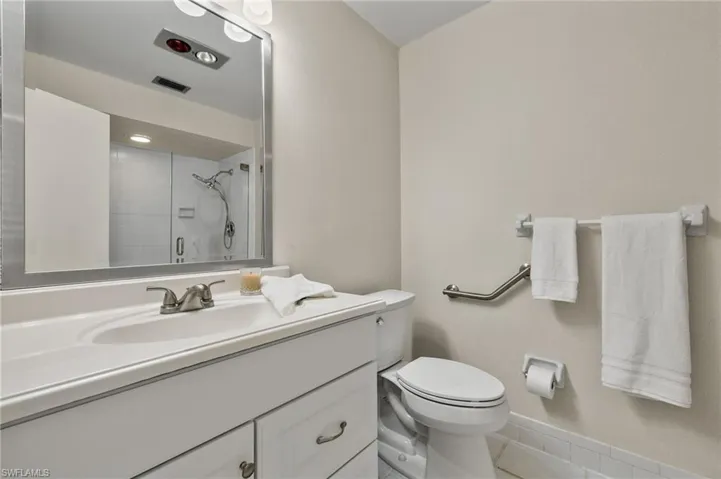Bathroom with tile floors, oversized vanity, and toilet