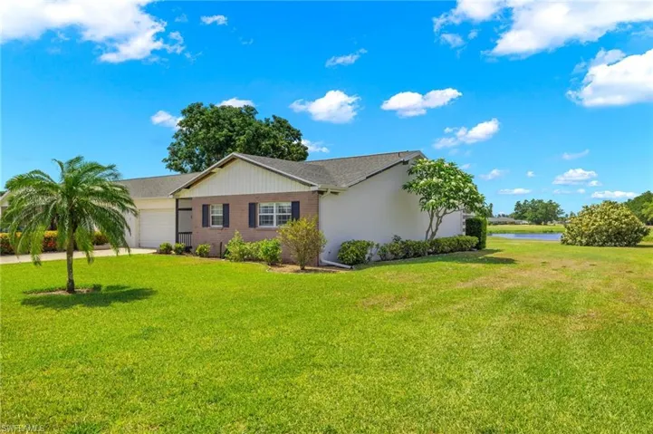 View of home's exterior featuring a garage and a lawn