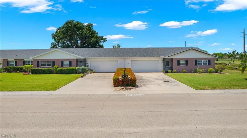 Single story home with a front yard and a garage