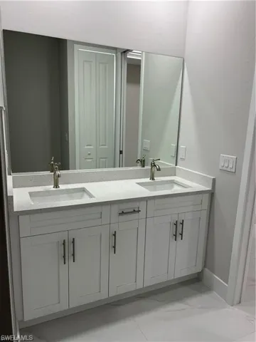 Unfurnished room with tile flooring, ceiling fan, and a raised ceiling