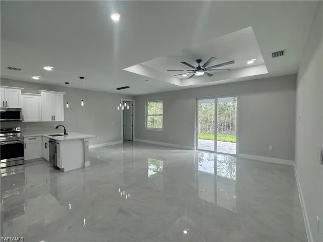 Kitchen featuring decorative light fixtures, white cabinetry, stainless steel refrigerator with ice dispenser, and ceiling fan