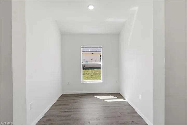 Spare room with wood finished floors and baseboards