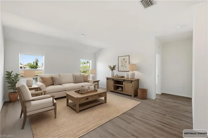 Living room with wood finished floors and lofted ceiling