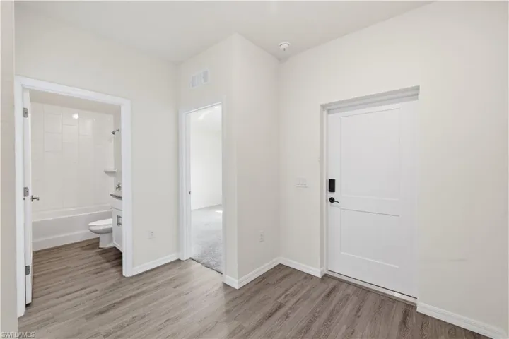 Entryway featuring light wood-type flooring and baseboards