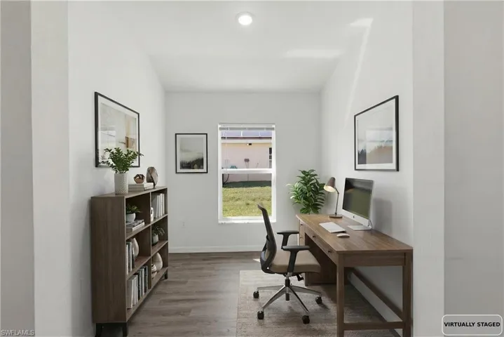 Home office featuring wood finished floors and baseboards