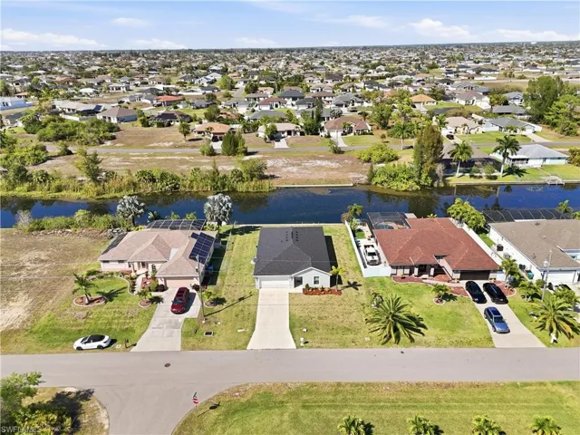 Aerial perspective of suburban area with a large body of water