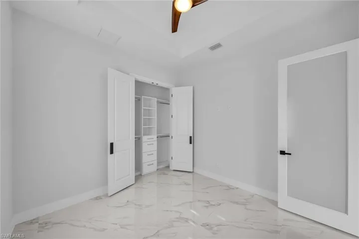 Unfurnished bedroom with a closet and ceiling fan