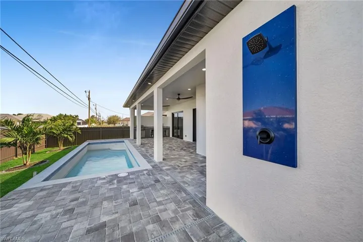 View of swimming pool featuring ceiling fan and a patio area