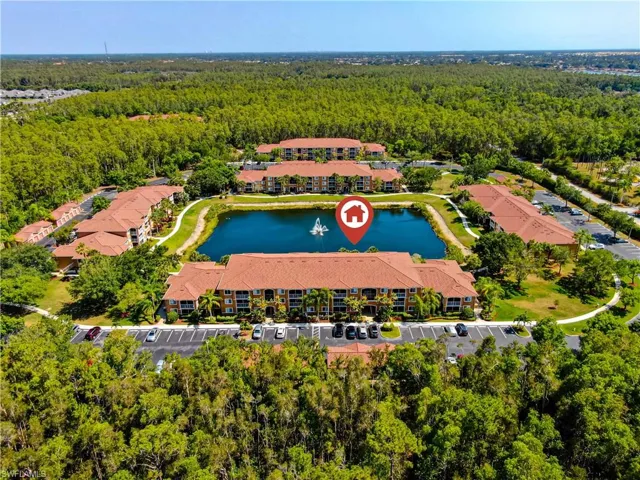 Birds eye view of property with a water view
